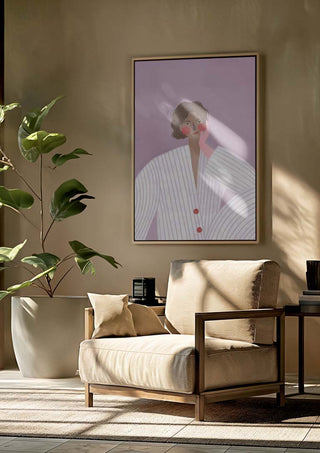 Framed art print of "The Woman With the Pink Glove" by Bea Muller hanging above a beige armchair.
