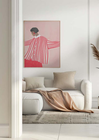 The Woman With the Red Stripes by Bea Muller hanging above a white sofa in a modern living room.