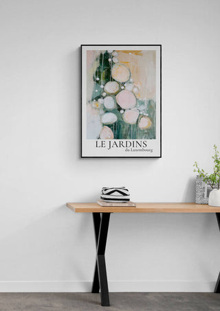 Framed Le Jardin Du Luxembourg 01 abstract art print hanging above a wooden table with decor.