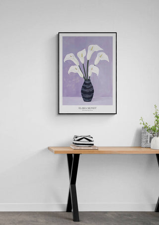 Blossoming Purple Dreams by Elara Monet, framed floral art print on a white wall above a modern wooden table.