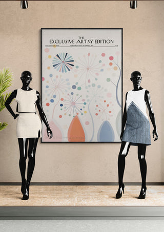 Two mannequins in modern dresses stand beside a Whimsical Flowers Artsy Edition poster with abstract floral designs.