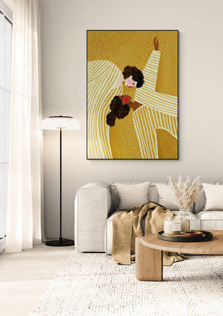 Framed "Two Line Women" by Bea Muller hangs above a light sofa in a modern, softly lit living room.