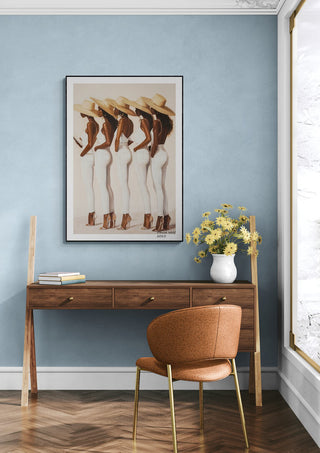 Framed "Ladies" artwork by David Wolf displayed above a wooden console in a modern, stylish room.