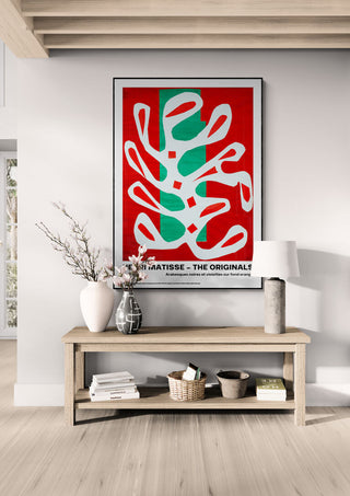Framed "Arabesques" by Henri Matisse displayed above a wooden console in a modern living room.