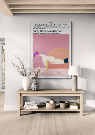 Framed "Party Hard - Nap Harder Artsy Edition" poster displayed above a wooden console table in a modern room.