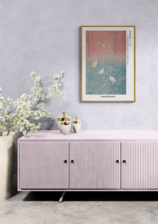 Song of the Forest Japandi woodblock print hanging above a pink cabinet with vases and white flowers.