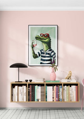 Framed Zoomelier - Martin Zen art print above a minimalist shelf with books, lamp, and pink vase on a pastel wall.