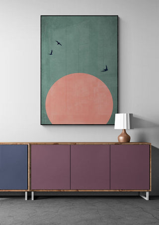 A Beautiful Day by Boris Draschoff, large wall art with a pink sun and birds above a modern cabinet and lamp.
