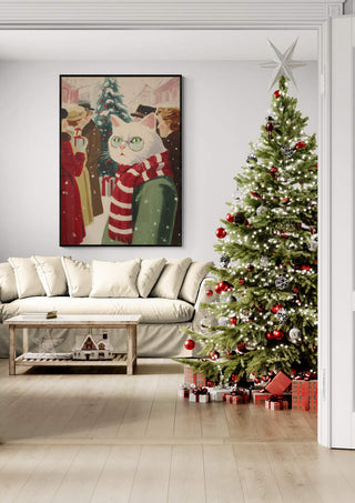 Framed "Hey Look it’s White Cat" art hangs above a sofa beside a decorated Christmas tree with gifts.