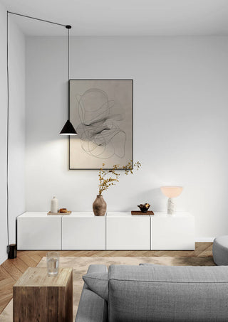 Minimalist living room featuring a Labyrinth of Dreams artwork above a white sideboard and modern decor.