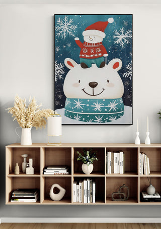 Framed art of a polar bear in a scarf with a Santa figure on its head, surrounded by snowflakes.