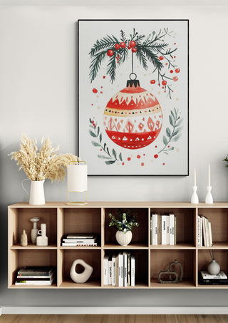 Framed festive ornament artwork with pine and berries displayed above a modern shelf, perfect for Season’s Greetings décor.