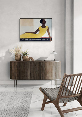 Framed Bauhaus Weimar Collection poster by David Wolf hanging above a wooden console in a modern living room.