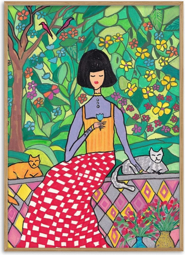 The Garden Wall by Camilla Nilsson - a woman with two cats on a tiled wall in a flowering garden