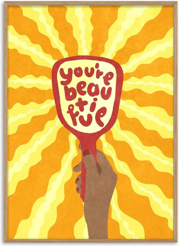 Illustration of a hand holding a mirror with "you're beautiful" and yellow rays in the background.