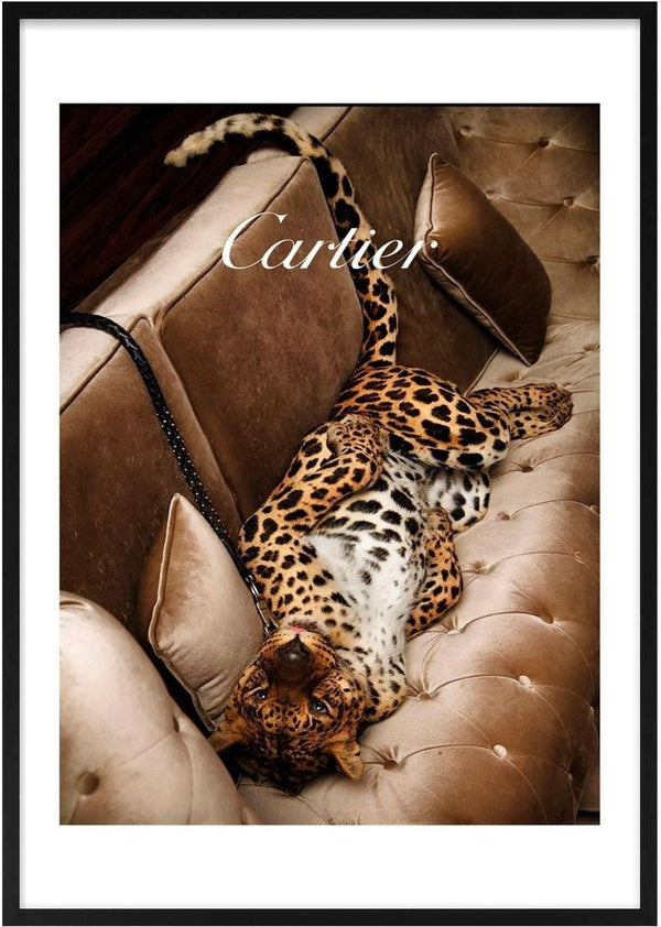 A leopard lounges on a luxurious beige velvet sofa, showcasing elegance for Cartier Fashion.