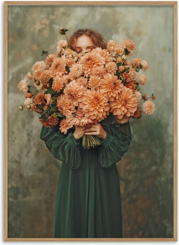 A woman in a green dress holds a large bouquet of peach flowers, partially covering her face.
