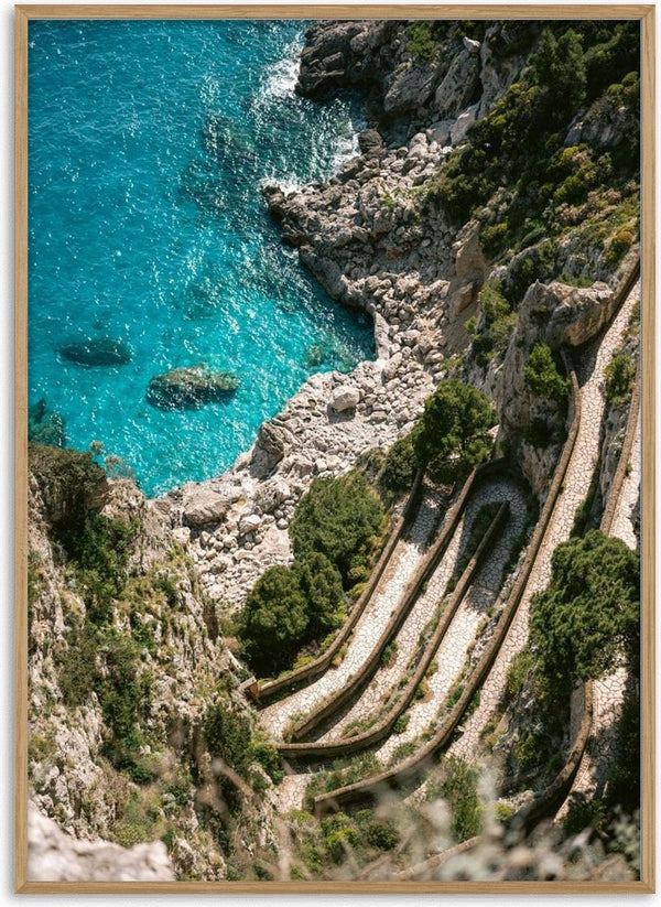 Scenic view of Gardens of Augustus terraces overlooking turquoise sea and rocky coastline.