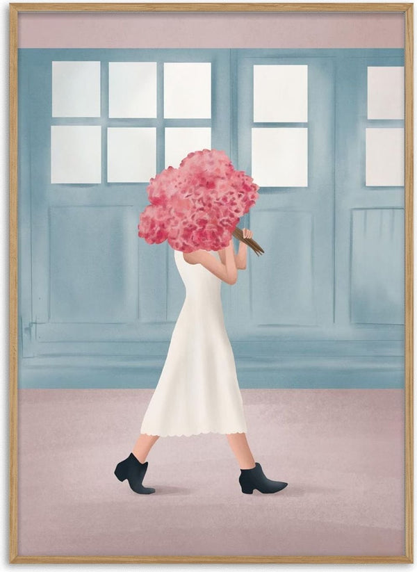 Woman in a white dress holding a bouquet of pink flowers, walking past blue windows.