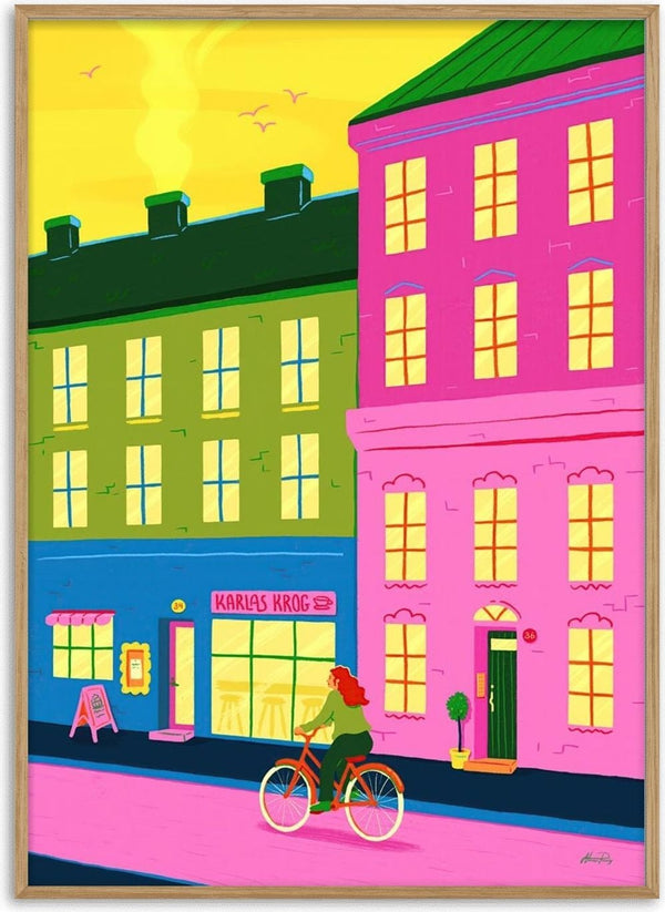 Illustration from "Home Through The City" by Nanna Paavig, showing a woman biking past colorful city buildings.
