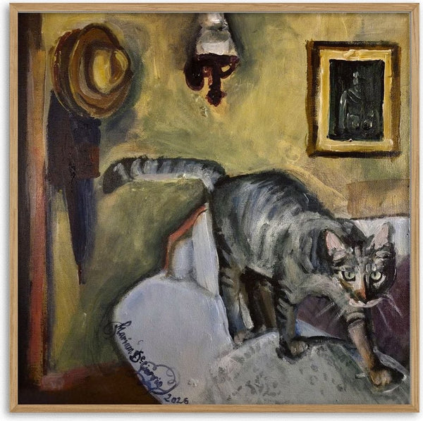 Mathilda by Mariam De Giorgio - a grey tabby on an armchair back against an ochre wall with a straw hat