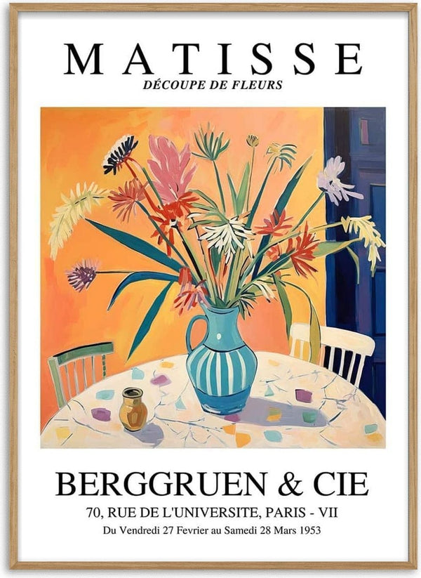 Colorful cut-out style flowers in a blue-striped vase on a round table, inspired by Matisse artwork.
