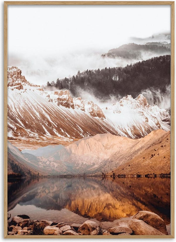 Poster of a tranquil lake reflecting snow-capped mountains and misty forest in warm, natural tones.