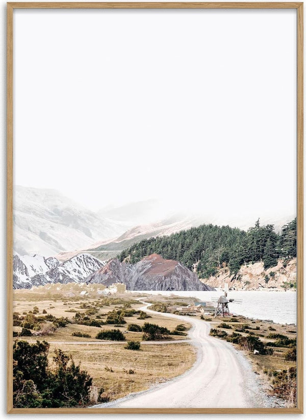 Scenic mountain road winding through snowy hills and pine trees, featured on Mountain road Plakat.