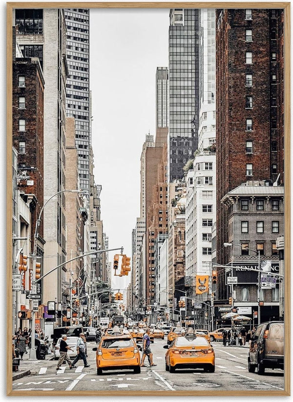 Yellow taxis and busy street scene surrounded by tall buildings in New York City.