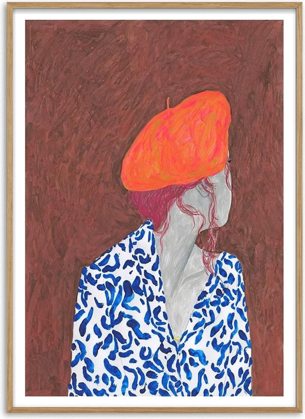 Illustration of a person in a blue patterned shirt wearing an orange Phrygian cap, facing sideways.