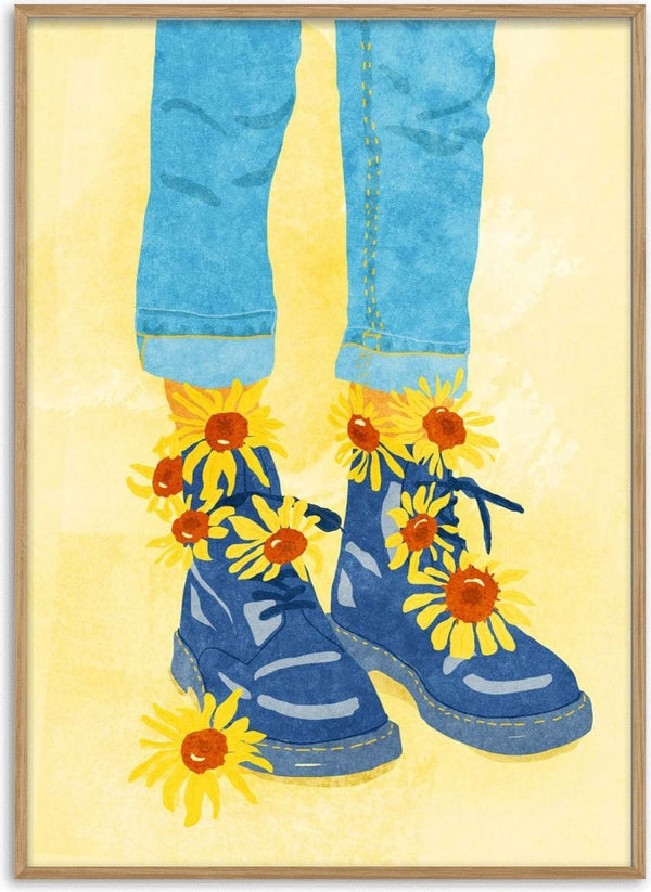 Illustration of blue boots with sunflowers, worn by a person in rolled-up jeans on a yellow background.