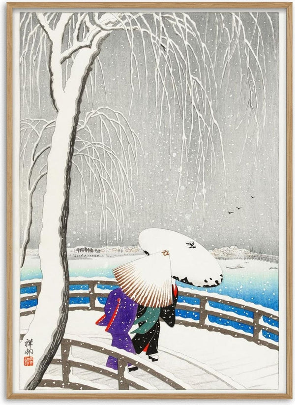Two women with umbrellas walk on a snow-covered bridge by the water, surrounded by bare winter trees.