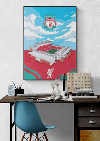 Illustrated Anfield Liverpool Stadium football poster hanging above a desk with stationery and decor items.